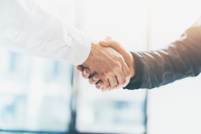 Business partnership meeting. Picture businessmans handshake. Successful businessmen handshaking after good deal. Horizontal, blurred background